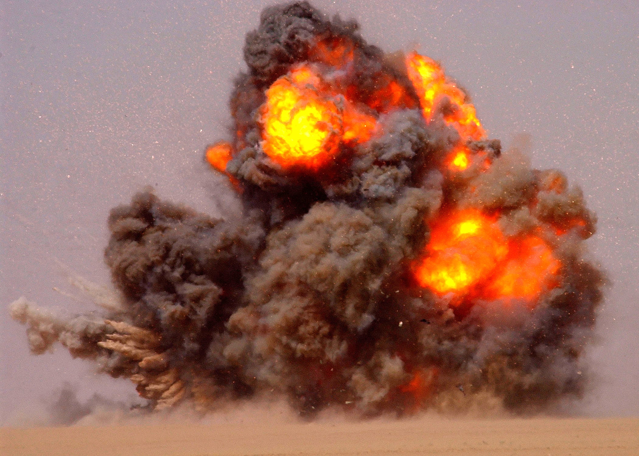020712-N-5471P-010 Udairi Range, Kuwait (Jul. 12, 2002) -- Explosive Ordnance Disposal (EOD) technicians explode or "Cook off" old ammunition and ordnance that is no longer usable. EOD technicians use C-4 Plastic explosive charges to completely destroy the weapons. EOD teams from the U.S. Army, Navy, Air Force, and coalition forces conduct training exercises to improve joint capabilities between the services. U.S. Navy photo by PhotographerÕs Mate 2nd Class Aaron Peterson. (RELEASED)